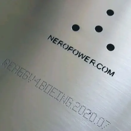 Laser-etched marking and precision-drilled holes on a machined stainless plate