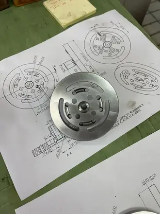 Turned aluminium flange beside its production drawing